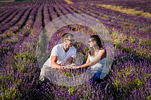 Couple in love on lavender fields. Boy and girl in the flower fields