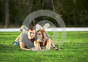 Couple in love lies on the lawn in the park