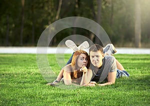 Couple in love lies on the lawn in the park