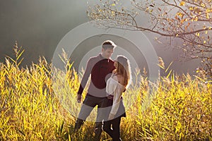 Couple in love looking one at each other in fields of reeds / Young couple looking in each other`s eyes with love in beautiful