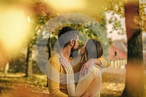 Couple in love. Love relationship and romance. Man and woman at yellow tree leaves. Autumn happy couple of girl and man
