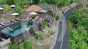 Couple In Love At Luxury Resort On Romantic Summer Vacation. People Relaxing Together In Edge Swimming Pool , Enjoying