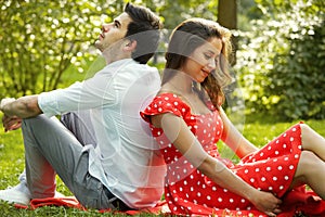 Couple in love lying on the grass in the park