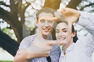 Couple in love making shap square with hands and looking camera at nature,Happy moments together