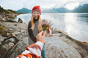 Couple in love man hand giving bouquet flowers to woman travel lifestyle romantic vacations