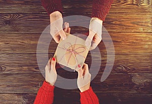 Couple in love. Man hold woman`s hand top view image on wooden background.