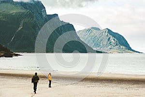 Couple in love Man running to Woman at sea Norway beach Travel happy emotions Lifestyle