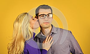 Couple in love. man and woman embrace. smart looking guy wear glasses. sexy bonde girl kiss and hug her boyfriend. happy photo