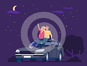 Couple in love. Man and woman sitting on roof of car and looking at stars in dark night sky. Romantic dating. Lovers