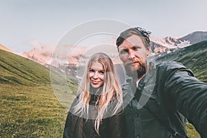 Couple in love Man and Woman together taking selfie in mountains Travel Lifestyle concept tourists at romantic