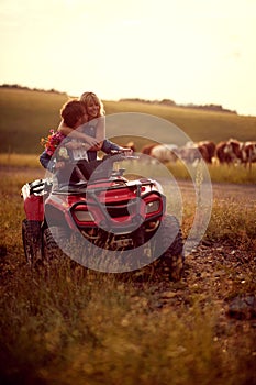 Couple in love on the mountain.Wedding in nature. man and woman enjoying a quad atv vehicle