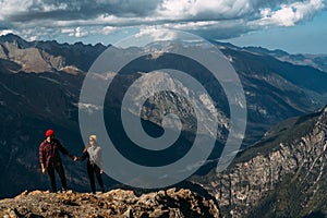 Couple in love in the mountains at sunset. Tourists on the tour. Couple in the Caucasus mountains, Russia.