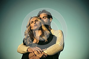 Couple in love. Muscular man and woman with long blond hair, love.