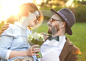 Couple in love in nature hugging with flowers on St. Valentine`s