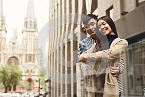 Couple in love near glass barrage.