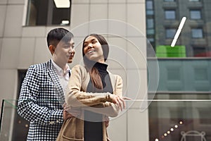 Couple in love near glass barrage.