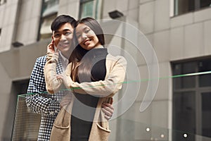 Couple in love near glass barrage.