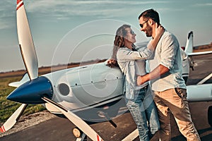 Couple in love near private plane