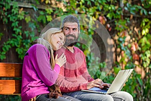 Couple in love notebook consume content. Internet surfing concept. Couple with laptop sit bench in park nature