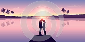 couple in love by the ocean at sunset with mountain and palm tree view
