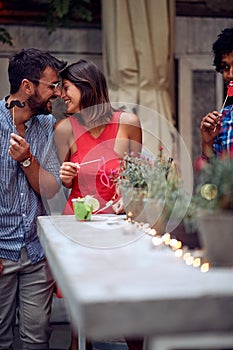 A couple in love at the open air birthday party. Quality friendship time together