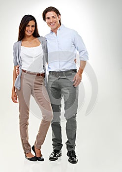 Couple, love and people standing together looking happy, confident and excited isolated in studio white background