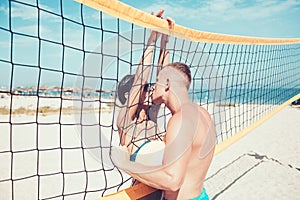 Couple in love play volleyball on sunny beach. Summer vacation and travel on holiday in Miami. Love and flirting of