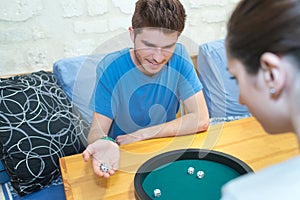 couple in love playing ludo board game