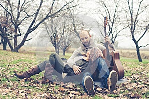 Couple in love playing serenade with guitar