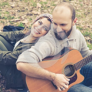 Couple in love playing serenade with guitar