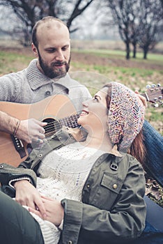 Couple in love playing serenade with guitar