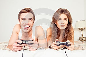 Couple in love playing video games in bedroom