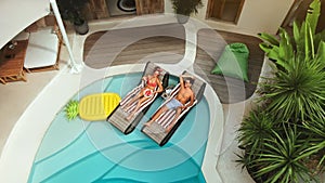 Couple In Love At Pool. Aerial View Of Happy Man And Woman On Summer Vacation. Fashion Male And Female Chilling.