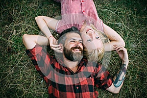 Couple in love relax on green grass. Couple in love enjoy summer day on nature.