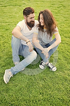 Couple in love relaxing on green lawn. Lovely couple outdoors. Soulmates closest people. Simple happiness. Couple photo