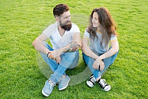 Couple in love relaxing on green lawn. Playful girlfriend and boyfriend dating. Lovely couple outdoors. Soulmates