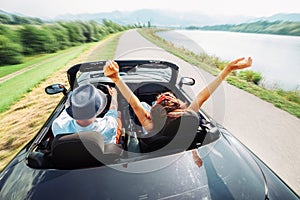 Couple in love ride in cabriolet car