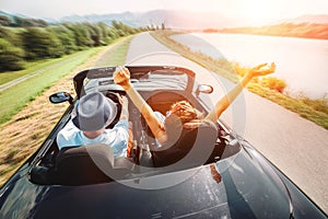 Couple in love ride in cabriolet car