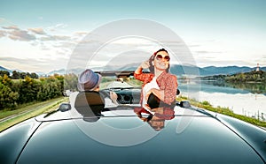 Couple in love ride in cabriolet on the picturesque mountain road