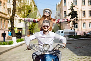 Couple in love riding a motorbike , Handsome guy and young woman travel . Young riders enjoying themselves on trip.