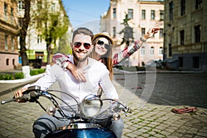 Couple in love riding a motorbike. Young riders enjoying themselves on trip.