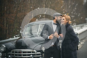 Couple in love on romantic date. Escort of girl by security. Travel and business trip or hitch hiking. Bearded man and