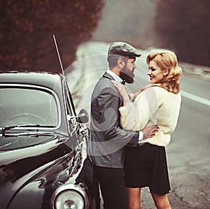 Couple in love on romantic date. Travel and business trip or hitch hiking. Bearded man and sexy woman in fur coat. Retro