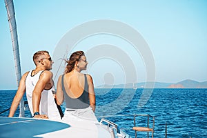 Couple in love on a sail boat yacht in the summer holiday vacation.