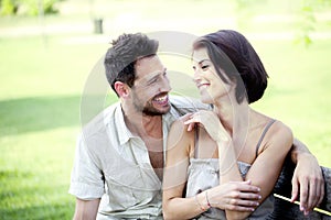 Couple in love seated together on a bench