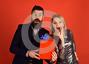 Couple in love shares presents on red background