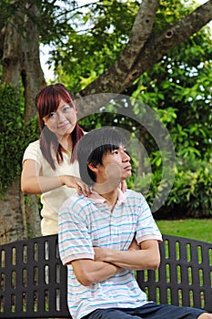 Couple in Love sitting on bench giving massages 2