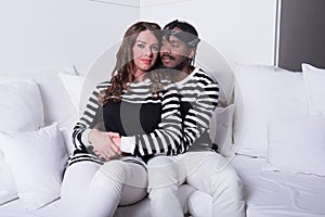 Couple in love sitting on couch
