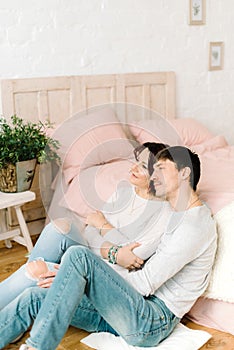 Couple in love sitting on the floor