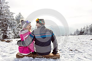 Couple in love sitting on ski terrain